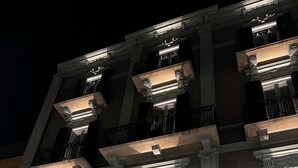 A multi-story building with balconies, large windows, and a prominent entrance door. - Vis Urban Suites & Spa (Bari)