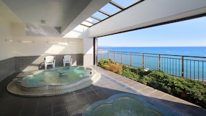 A rooftop spa area with a hot tub and seating, overlooking a scenic ocean view. - Yumemisaki (Minamiboso)