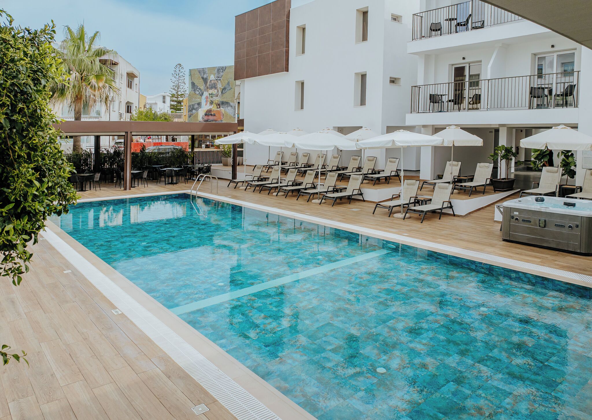 Seasonal outdoor pool, open 10:00 AM to 7:00 PM, pool umbrellas