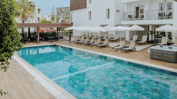 Seasonal outdoor pool, open 10:00 AM to 7:00 PM, pool umbrellas