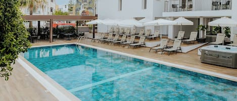Seasonal outdoor pool, open 10:00 AM to 7:00 PM, pool umbrellas