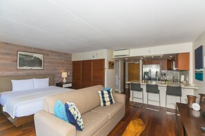 A hotel room with a bed, a sofa, a dining table, and a kitchen area. - Free WiFi/No Resort Fees/Oceanview at the Ilikai Hotel!  Beautiful Sunset Views! (Honolulu)