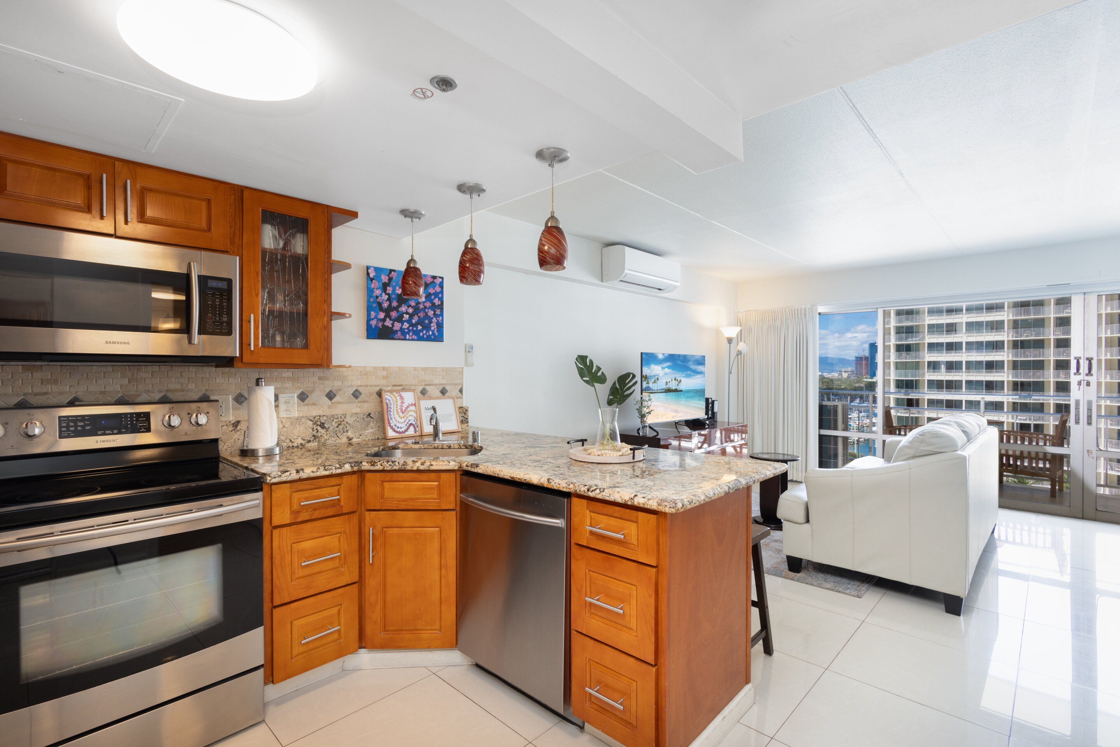 A modern kitchen with stainless steel appliances, wooden cabinets, and a large island.