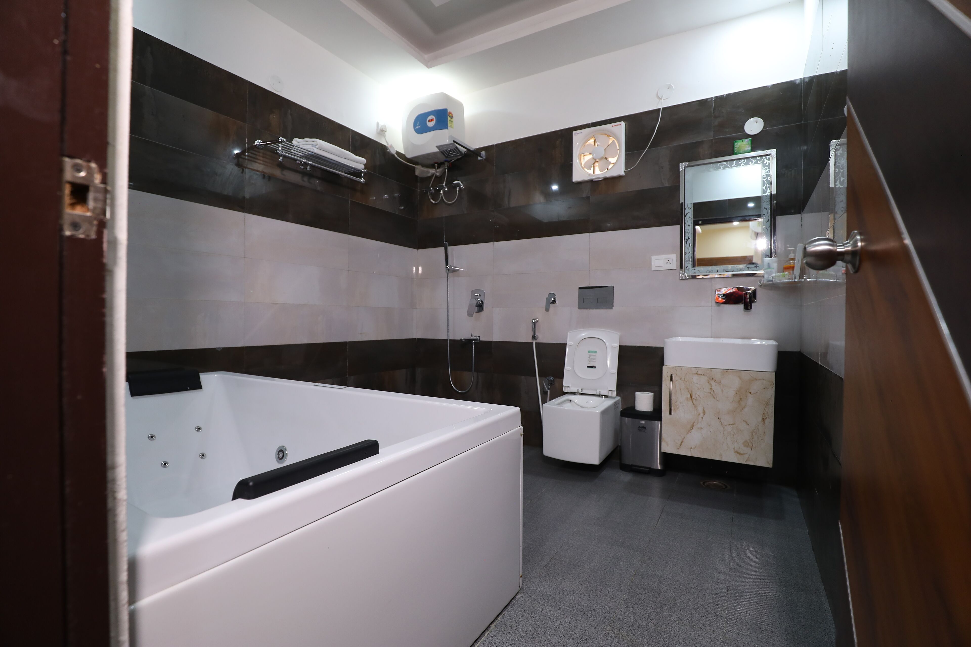 Jetted bath, rainfall showerhead, eco-friendly toiletries, towels