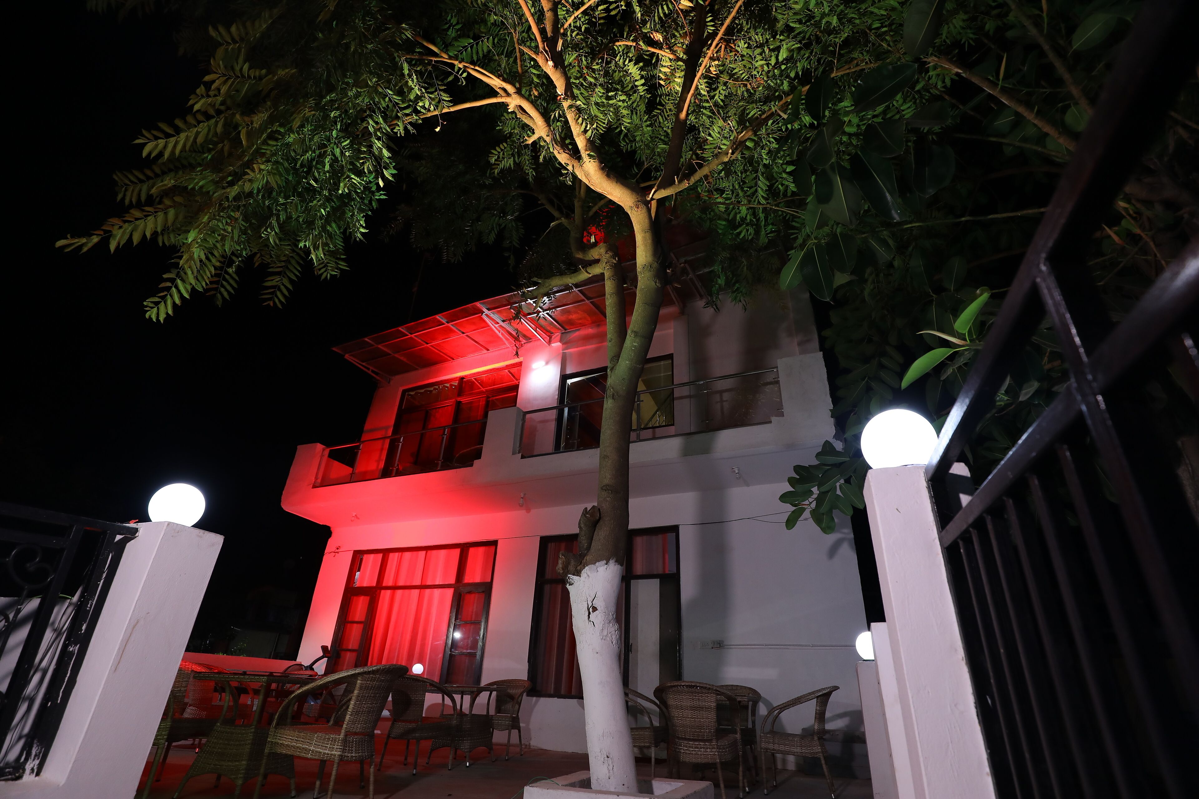 A two-story building with a balcony and outdoor seating area.