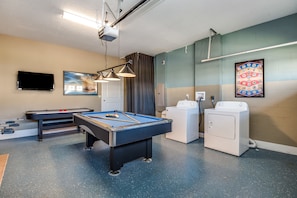 Relax and unwind in this hotel's recreational room, featuring a pool table, flat-screen TV, and laundry facilities.