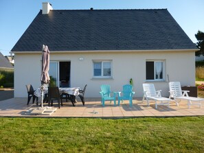 Enjoy dining al fresco on the patio with a table set for two.