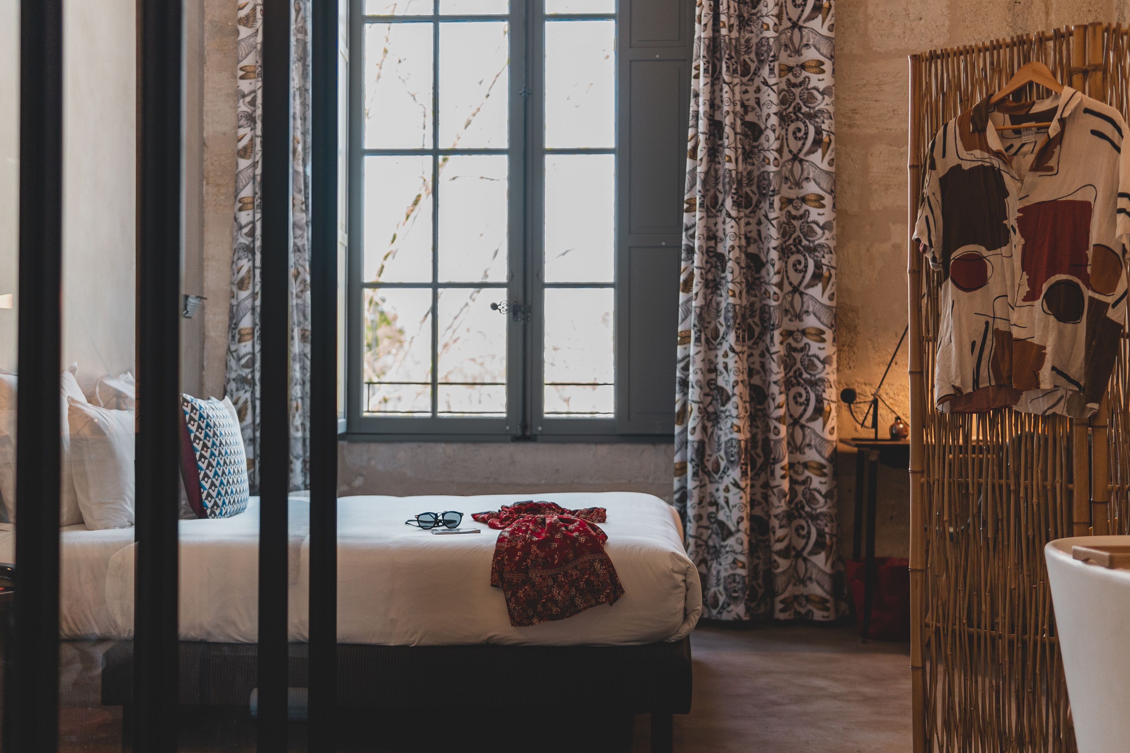 A bedroom with a bed, a window, and a wardrobe.
