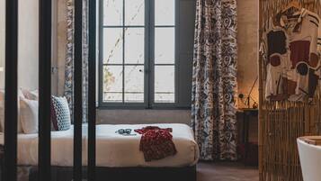A bedroom with a bed, a window, and a wardrobe.