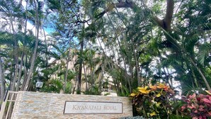A sign for "Ka'anapali Royal" with a stone wall and tropical plants. - Beautiful updates--everything new! Golf course views!  Huge 2/2 K. Royal #A301 (Lahaina)