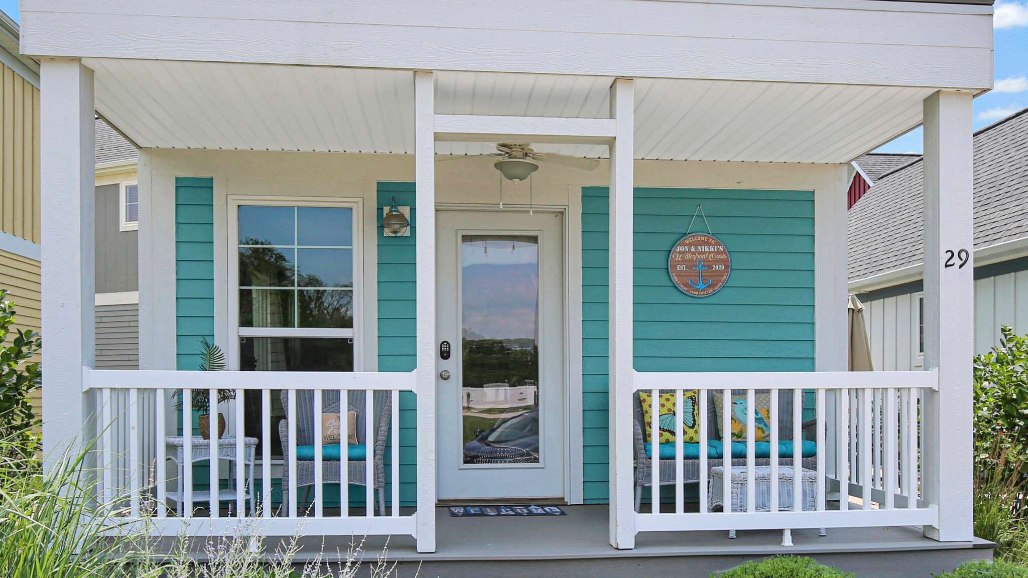 A house with a porch, a door, and a sign.