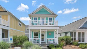 A two-story house with a balcony, a porch, and a small garden area. - Star Gaze on your Private Second Level Deck! (Ottawa)