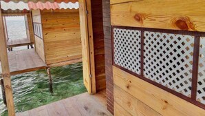 A wooden cabin with a wooden deck extending over water. -  Paradise Over the Water Cabins in San Blas (Narganá)