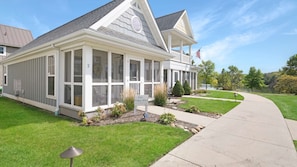 A single-story house with a covered porch, a flag, and a sign that reads 'Our Happy Place #2'. - Panoramic Views of the Illinois Waterway (Ottawa)