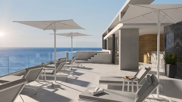A modern outdoor lounge area with multiple sun loungers and umbrellas, overlooking the sea. - Senator Cala Millor Hotel (Son Servera)