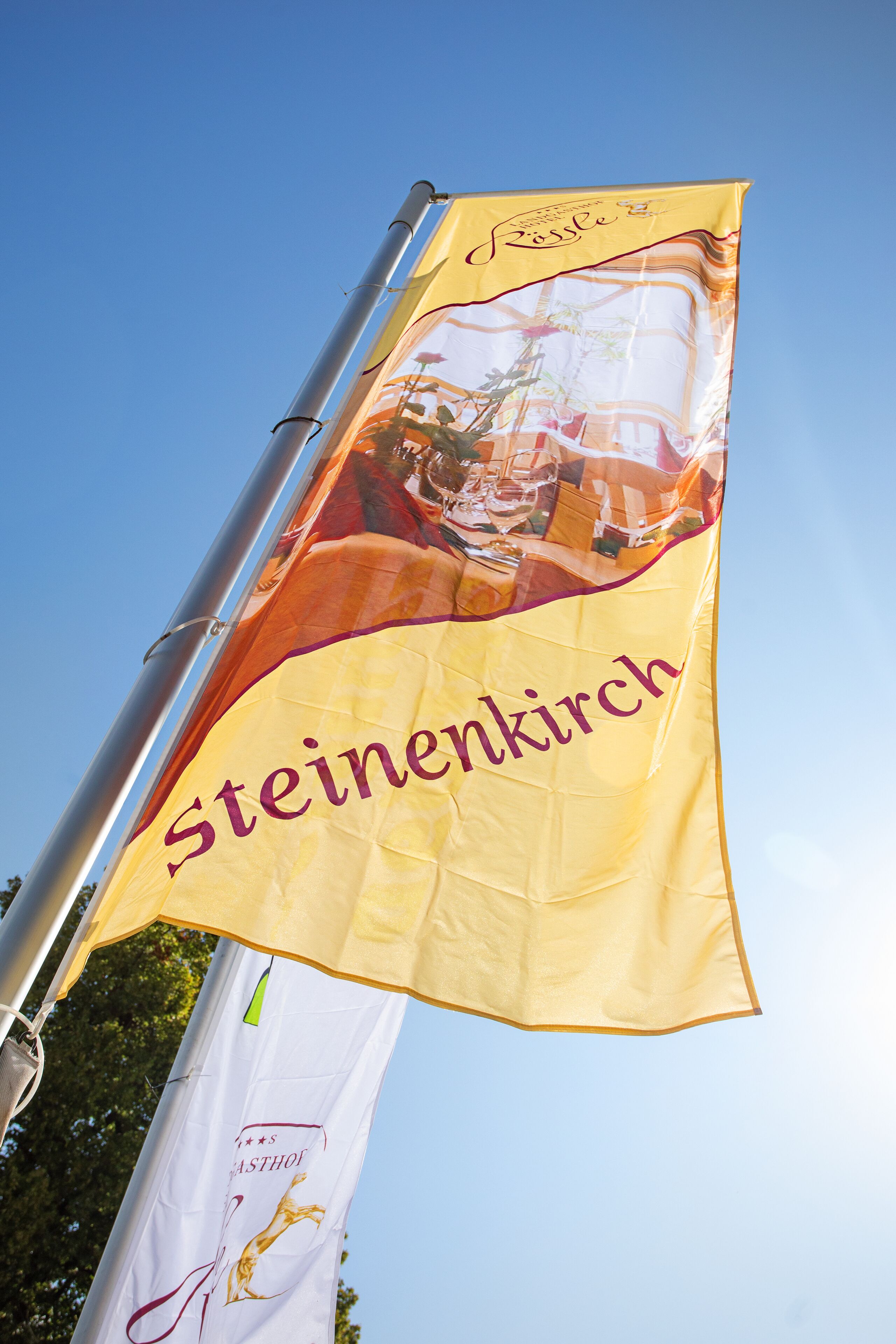 A flag with the text "Steinenkirch" and a logo.