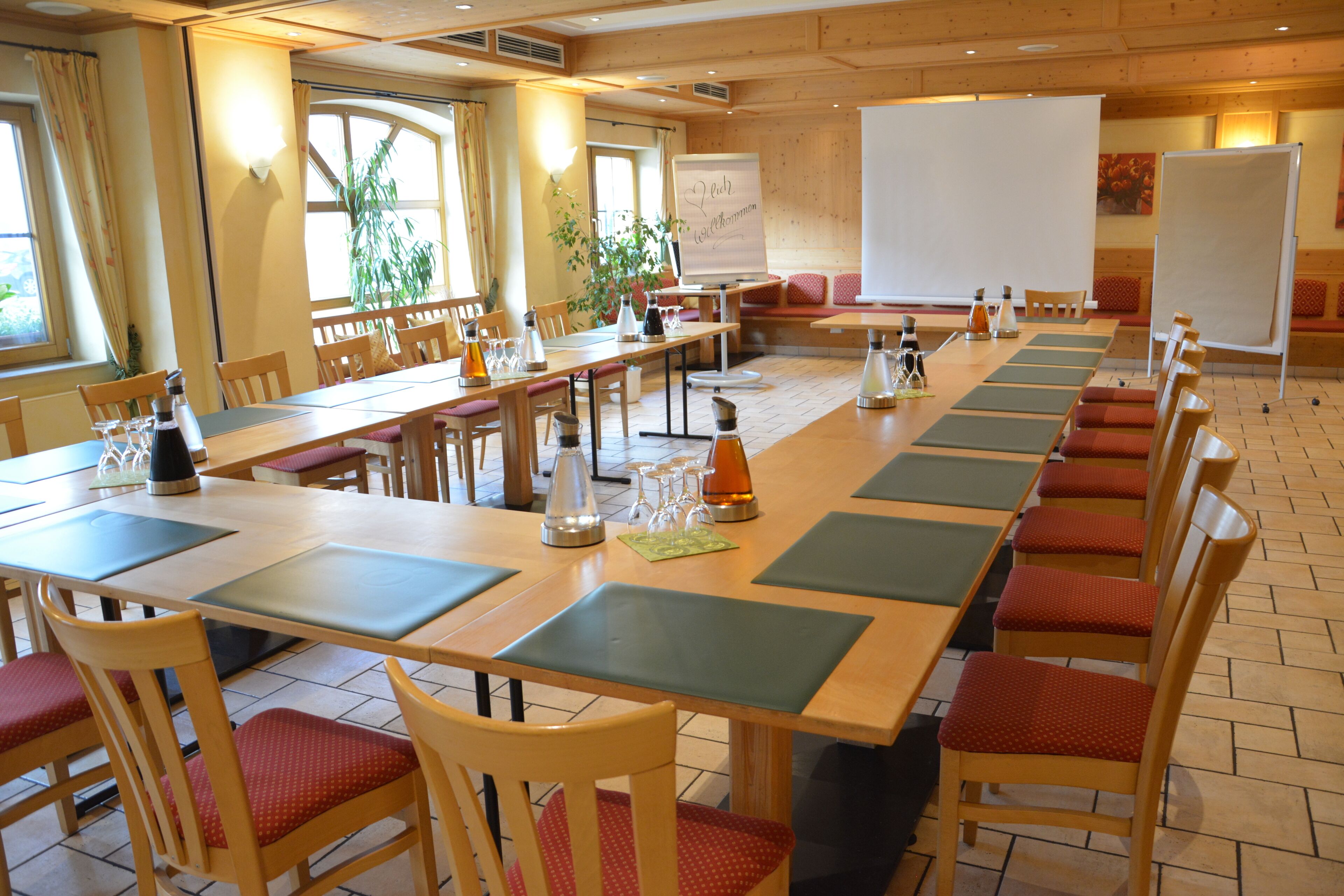 A conference room with a long table, chairs, and a whiteboard.