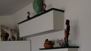 A modern interior with multiple glass shelves displaying decorative items. - NEW LISTING! Beachfront Villa (Manasquan)