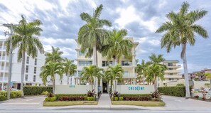 A multi-story hotel with a central entrance flanked by palm trees and a sign reading "CRESCENT".