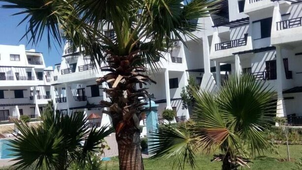A modern building with multiple balconies and a pool area. - Résidence Tamuda Golf (M'diq)