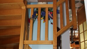 A wooden staircase with a floral decoration on the wall.