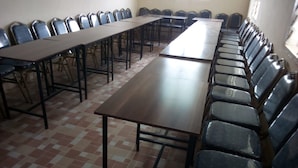 A conference room with long tables and rows of chairs. - Merybyplace Guest House (Kitui)
