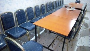 A conference room with a long table and rows of blue chairs. - Merybyplace Guest House (Kitui)