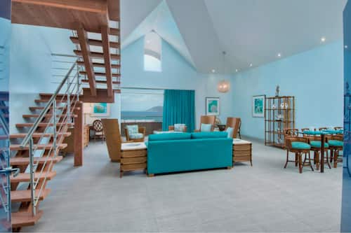 Deluxe Penthouse, Balcony, Ocean View (Cool Water 1) | Living area | 55-inch Smart TV with satellite channels, TV, iPod dock