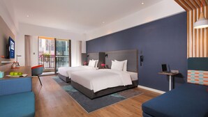 A modern hotel room with two beds, a sofa, a desk, and a balcony with flowers. - Holiday Inn Express Chengdu East by IHG (Chengdu)