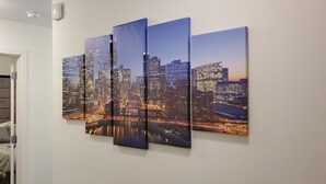 A multi-panel cityscape artwork on a wall.