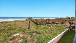 A beach view with a wooden boardwalk leading to a gazebo. - Beacher's Oceanfront Balcony Suite with onsite Front Desk and Staff (St. Augustine)