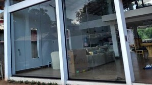 A modern building with large glass windows and a wooden exterior. - buzios season rental  (buzios)