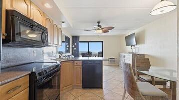 A modern kitchen with wooden cabinets, a built-in microwave, and a dishwasher.