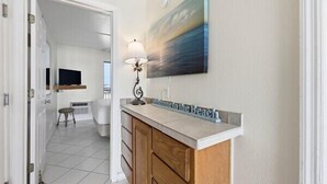 A bathroom with a sink, mirror, and towel rack.