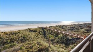 A coastal landscape with a wooden boardwalk leading to a beach. - Beacher's Oceanfront Balcony Suite with Onsite Front desk and staff (St. Augustine)