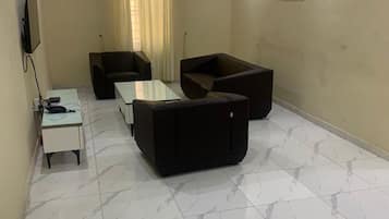 Deluxe Apartment | Living area | Flat-screen TV