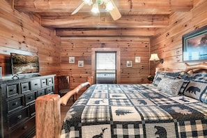 Relax in this charming bedroom with a large bed, wooden dresser, and comfortable chair.
