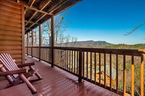 Relax on the cabin's deck with a serene mountain view.