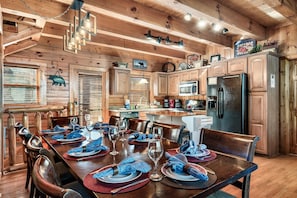 Enjoy a home-cooked meal in this cozy cabin-style kitchen, complete with a dining area and modern appliances.