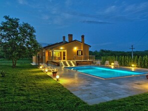 A two-story house with a swimming pool, outdoor seating, and a well-lit patio area. - NEW!! Spacious and luxurious apartment with private 50m2 pool! (Pazin)
