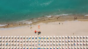 An aerial view of a beach with rows of beach umbrellas and sun loungers. - Valtur Otium Resort (Villapiana)