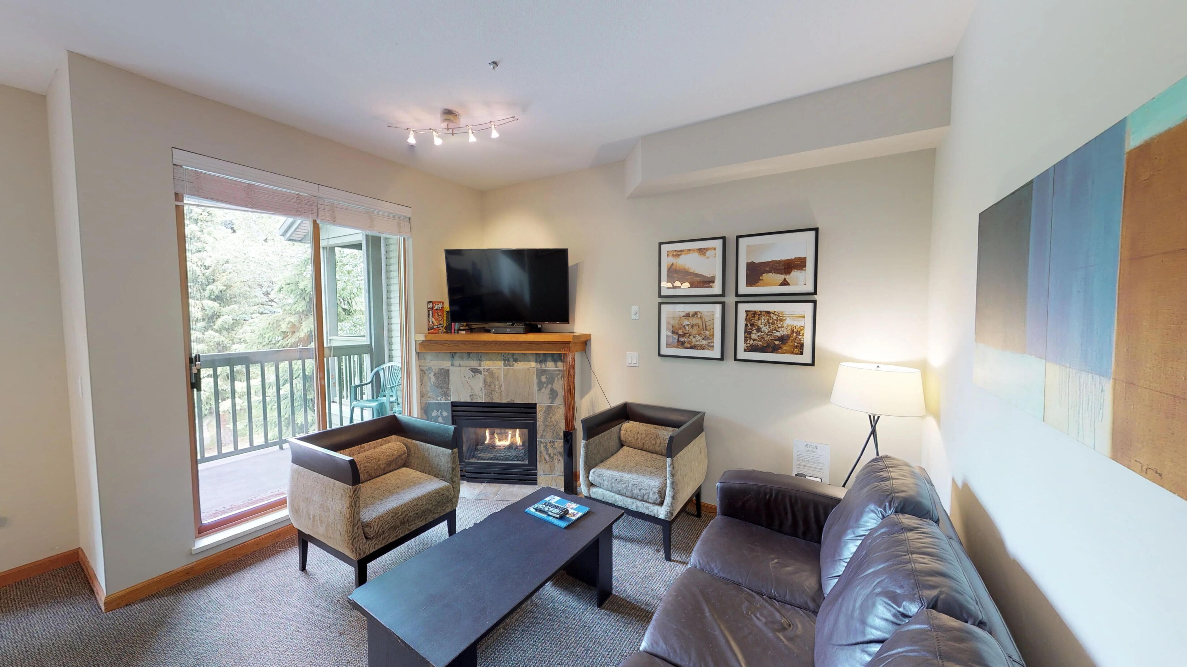 A living room with a fireplace, a television, and a sofa.