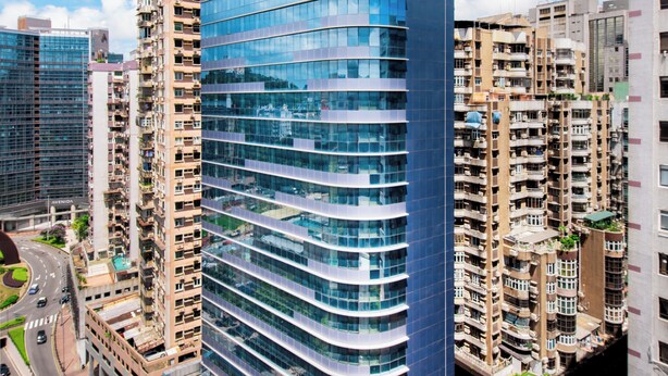 A modern hotel with a curved facade, multiple balconies, and a prominent sign at the top. - Holiday Inn Express Macau City Centre (Macau)