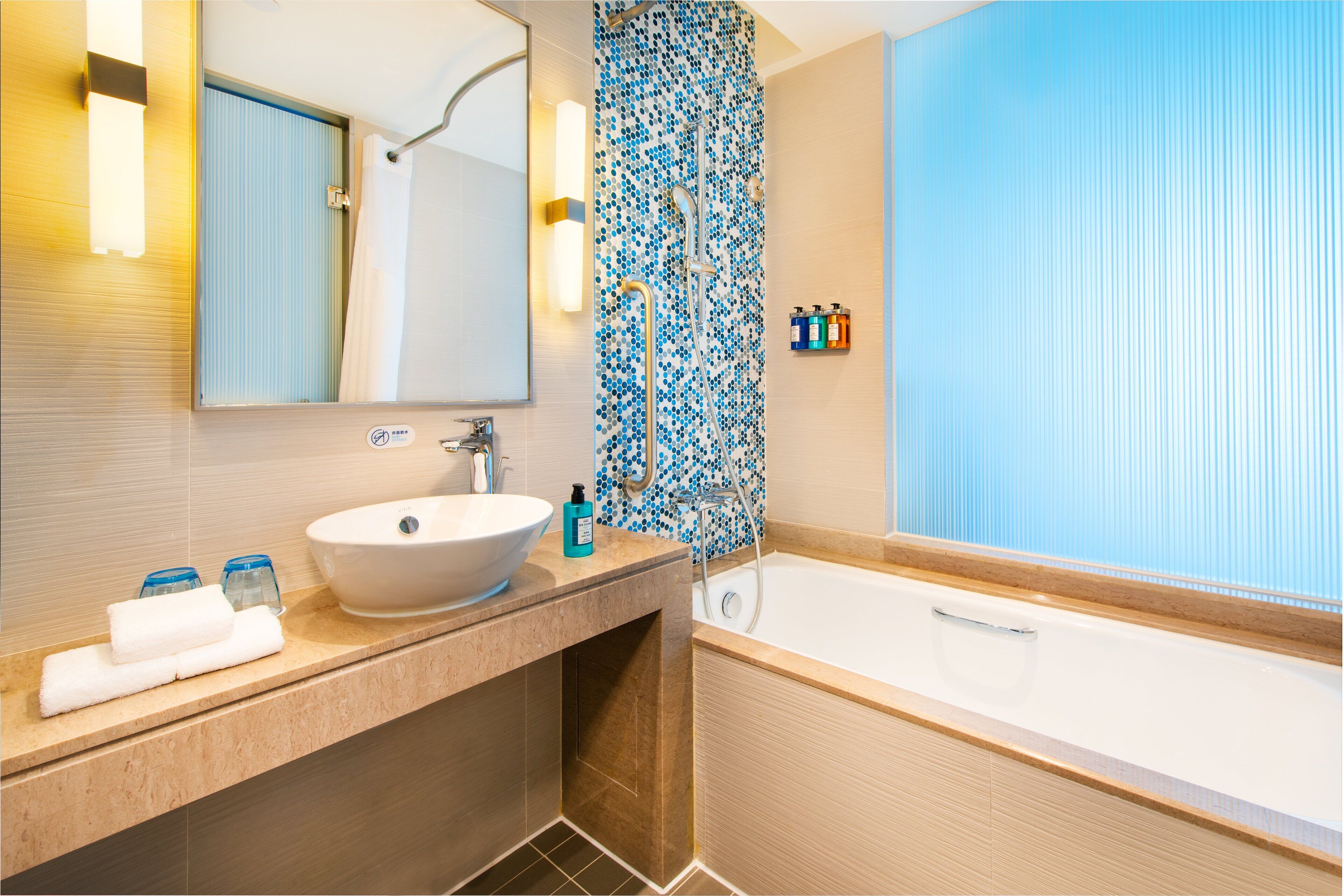 rainfall showerhead, hair dryer, slippers, towels