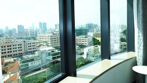 A high-rise building with a view of a cityscape through large windows. - Holiday Inn Express Macau City Centre (Macau)