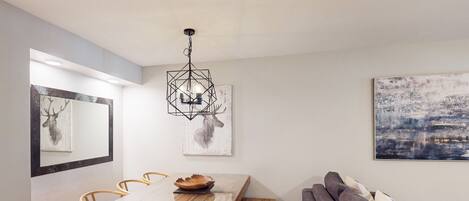 A modern dining area with a wooden table, chairs, and a bench.