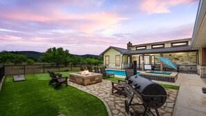 A backyard with a fire pit, outdoor seating, a barbecue grill, and a swimming pool. - Private pool & hot tub, outdoor kitchen, putting green & more, 5-minute drive to THE Frio River (Concan)