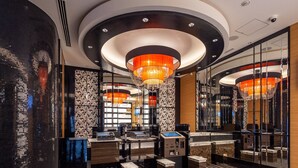 A modern hotel lobby with a large chandelier, check-in counters, and a patterned floor. - APA Hotel Omori Ekimae (Tokyo)