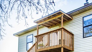 A two-story wooden deck with a staircase leading to a balcony. - Farmhouse right off of I-5 (Tangent)