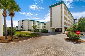Experience the hotel's modern design, featuring a multi-story structure with balconies and well-manicured grounds.